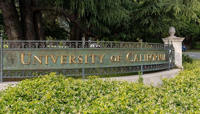 Image shows "University of California" on sign