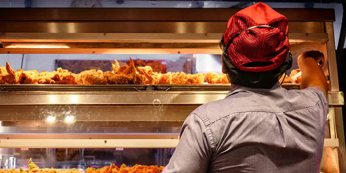 Photograph of a fast-food worker in a kitchen.
