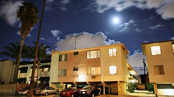 Photograph of a residential street with apartment buildings at night at Los Angeles, California.
