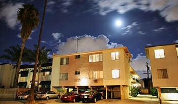 Photograph of a residential street with apartment buildings at night at Los Angeles, California.
