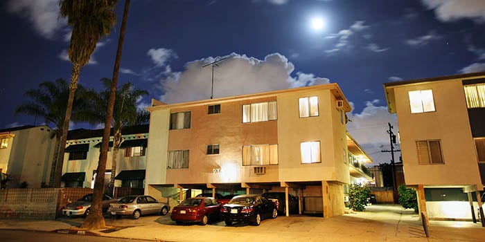 Photograph of a residential street with apartment buildings at night at Los Angeles, California.