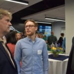 Mark Martin (Assembly Budget Committee) speaks with Aaron Kunst and Oscar Sandoval (both from Center for Health Communities)