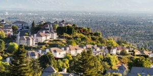 Photograph of San Fernando Valley view, with homes and green trees.