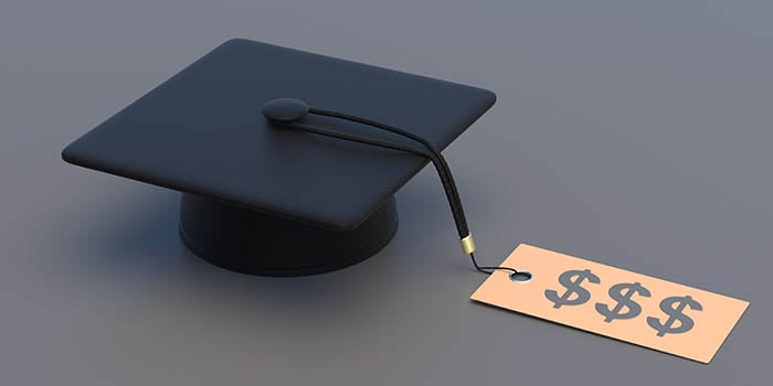 Photo of a graduation cap with a tag on it that shows a dollar sign