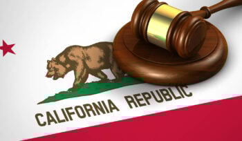Photo of a judge's gavel on top of the California flag
