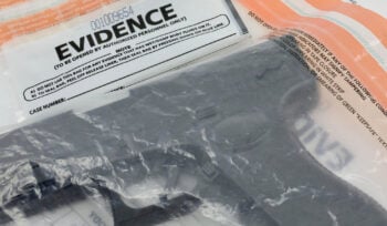 Photograph of a handgun in a plastic bag that says "EVIDENCE" at the top