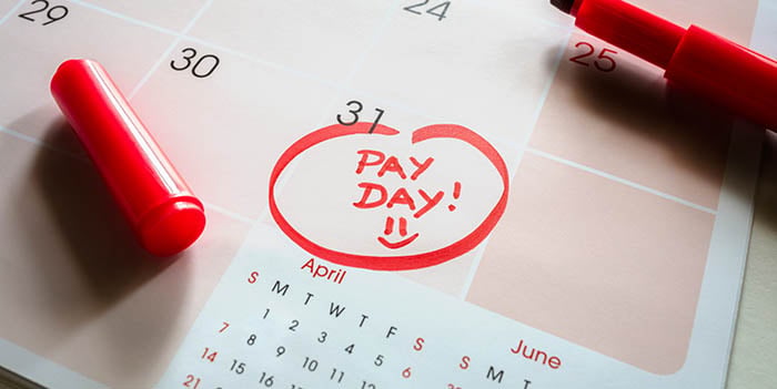 Calendar with red ink circled around the 31st and text says "PAY DAY!" with a smiley face